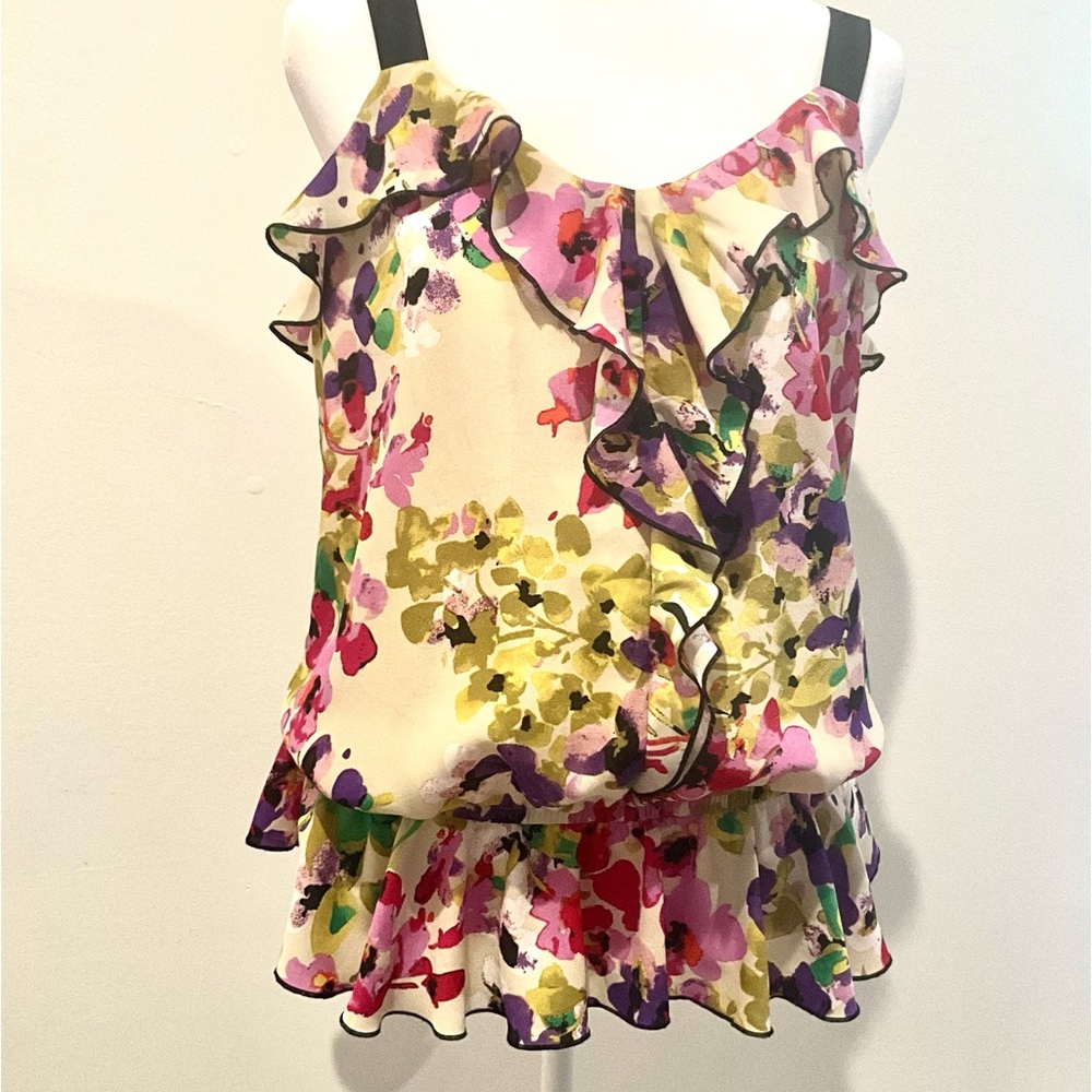 Express ruffles on neck, front & waist.  Multi colored flowers . Dude zipper. PS